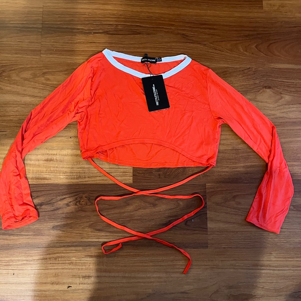 Long sleeved jersey knit blouse with waist strings  by PrettyLittleThing